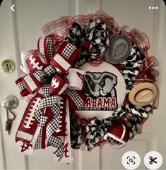 a wreath that is hanging on the front door with footballs and other items attached to it