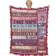 a woman holding up a quilt with words on it