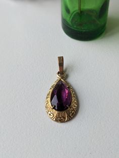 Was £48 now £33 This antique pendant is exquisite. The combination of the rolled gold and the purple paste stone is stunning.  The piece is stamped RG Foreign A ( star stamp) D. The condition is very god for its antique age.  The paste stone has light scratches and scuffs .  The prongs are tight.  There is some discolouration in the rolled gold mostly on the back and on the jump ring. Measurements:  App. 1 1/4 inches in total height by 1/2 of an inch in length All sales are final so please ask a Antique Pendant, Hollywood Glam, Jump Rings, Gold Tones, Jewelry Necklace Pendant, Jewelry Necklaces, Gift Card, Stamp, Pendant Necklace