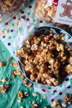 a bowl full of popcorn with a christmas sticker on the label next to it