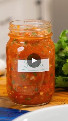 a glass jar filled with food sitting on top of a wooden table