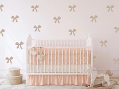 a baby's room with a crib, rocking horse and wall decals