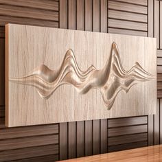 a wood panel with wavy lines on the front and back of it, mounted to a wall