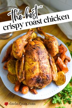 the best crispy roast chicken recipe on a white plate with carrots and potatoes