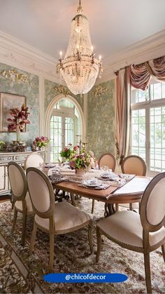 a dining room table with chairs and a chandelier