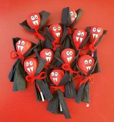 a group of red and black candy bats with eyes, mouths and teeth on them