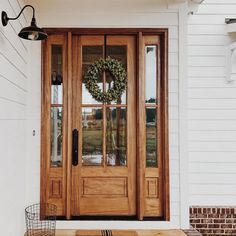 a wooden door with a wreath on it