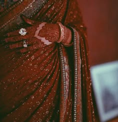 a close up of a woman wearing a red sari