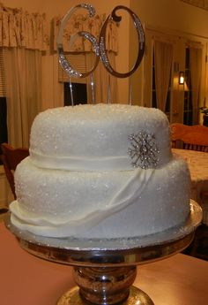 a three tiered wedding cake with white frosting