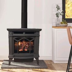 a small stove in the corner of a room with a table and chair next to it