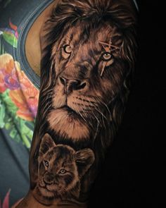 a man with a lion and cub tattoo on his arm