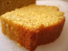 a piece of cake sitting on top of a white plate next to a slice of bread