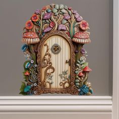 an ornate wooden door with mushrooms and flowers on it