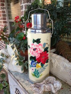 a white vase with flowers painted on it