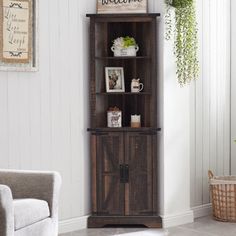 a tall wooden cabinet sitting next to a white wall