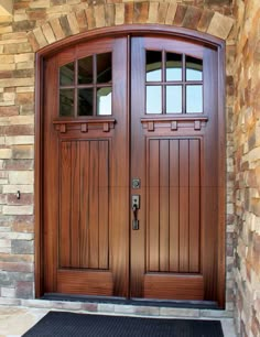 the front door is made of wood and has two sidelights