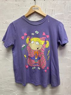 a purple shirt with a cartoon character on it