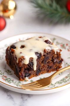 a piece of cake sitting on top of a white plate with a gold fork next to it