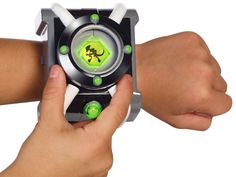 two hands holding an electronic wrist watch with green and white designs on the arm,