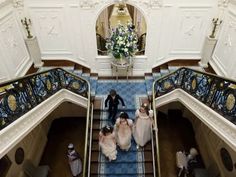 the bride and groom are walking down the stairs