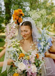 the bride is holding flowers in her hands