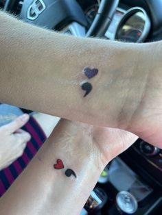 two people with matching tattoos on their wrist