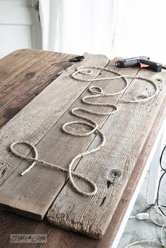 a wooden table with rope and scissors on it