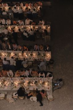 an overhead view of people sitting at long tables