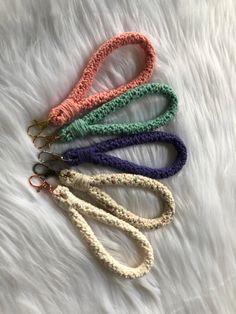 four crocheted lanyards on white fur