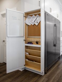 an open refrigerator freezer sitting inside of a kitchen