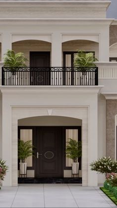 a large white house with two balconies on the second floor and an entry way