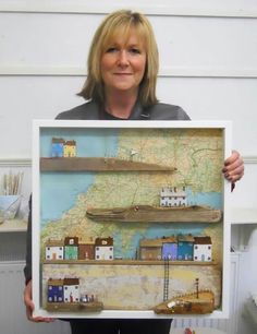 a woman holding up a map with boats on it