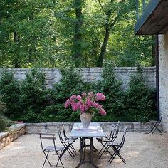 an instagram photo of a table and chairs with flowers in the vase on top