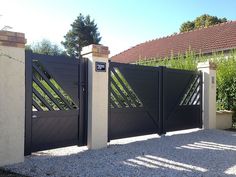 a black gate is in front of a house