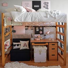 a loft bed with desk underneath it and lots of pillows on the bottom bunk beds