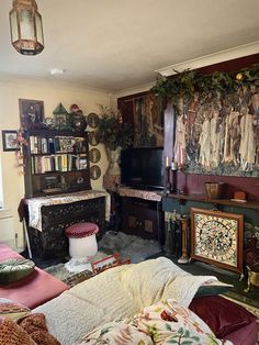 a living room filled with furniture and a fire place next to a painting on the wall