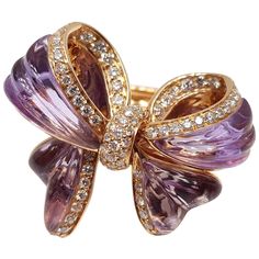 The finest Italian tradition of jewelry design and artisanal craftsmanship never fails to impress. This luscious bow ring is comprised of four custom cut amethysts and diamonds, resulting in a ring which is like no other. To be worn, admired and enjoyed for years to come. Style never goes out of style! 4 amethysts total weight 9.06cts 74 round diamonds total weight 0.89cts Viewed from above the ring measures 1 1/4 x 1 inches Jewellery Drawing, Amethyst Jewellery, Unique Bows, Gold Flower Ring, Jewellery Indian, Amethyst And Diamond Ring, Gold Cocktail Ring, Bow Ring, Contemporary Ring