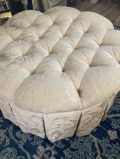 a large round bed sitting on top of a blue rug