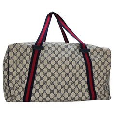 Expertly crafted in Italy, the Gucci Vintage GG Plus Weekender Duffle Bag features a classic GG logo coated canvas exterior with leather trimming. Boasting a spacious navy interior with a side zip pocket, this bag is perfect for any weekend getaway. With dual web fabric shoulder straps and a top zip closure, this bag is both stylish and functional. In very good condition, this bag is a must-have for any fashionista's trip. Designer: Gucci Material: Canvas, Leather, Web Accent Measurements: 18" x Gucci Overnight Bag, Navy Interior, Gucci Vintage, Gg Logo, Weekend Getaway, Carry On Bag, Canvas Leather, Duffel Bag, Fashion Handbags