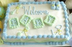 a baby shower cake is decorated with blue icing