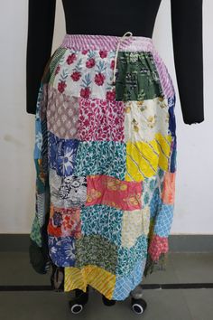 a woman's skirt made out of multicolored fabric with buttons on the side