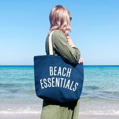 Your go-to tote for sunny seaside days! Our big canvas bags make the perfect spacious totes for your daily essentials and much more. Perfect for summer holidays, beach breaks and seaside escapes.  This hand illustrated 'Beach Essentials' design has been printed in off-white on sturdy ocean blue canvas. Suitable for carrying by hand or over the shoulder. Lovingly made in the UK. Hooray! Made in the UK 15oz thick blue canvas Deep flat base Mid-length handles 480mm by 390mm by 120mm (19 by 15½ by 4 Vacation Bag, Blue Tote Bag, Oversized Tote Bag, Beach Canvas, Oversized Tote, Blue Tote, Canvas Bags, Blue Beach, Beach Essentials