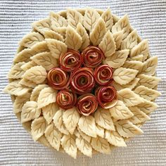 a close up of a flower made out of pasta noodles with spirals on it