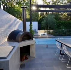 an outdoor kitchen next to a swimming pool