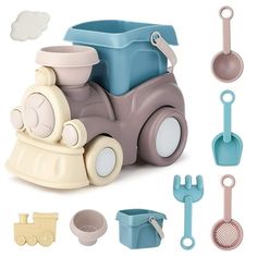 a toy train with lots of kitchen accessories around it on a white background, including utensils and spoons