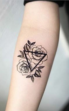 a black and white rose tattoo on the right arm, with an arrow in it