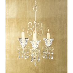 a white chandelier with three candles hanging from it's sides and one candle in the middle