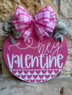 a sign that says happy valentine hanging on a stone wall