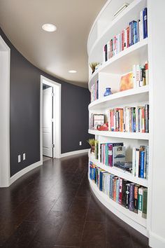 a curved book shelf filled with lots of books