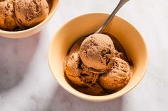 two bowls filled with ice cream on top of a white counter next to each other